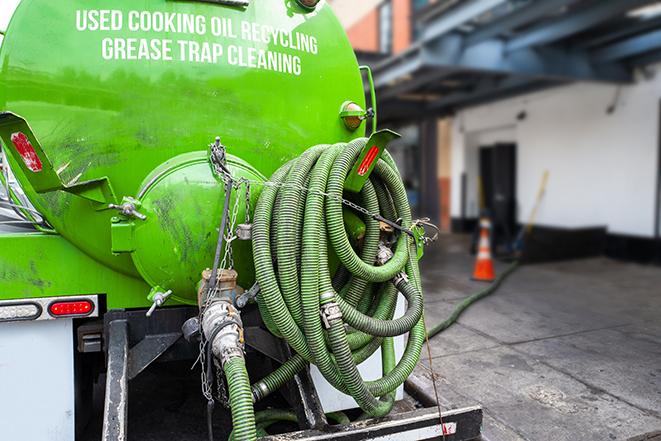 large truck pumping grease trap at a restaurant in Ballston Lake